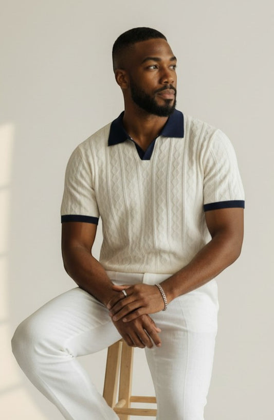 Tuck It cream cable knit polo shirt with navy collar and cuffs. Short sleeves, V-neck.