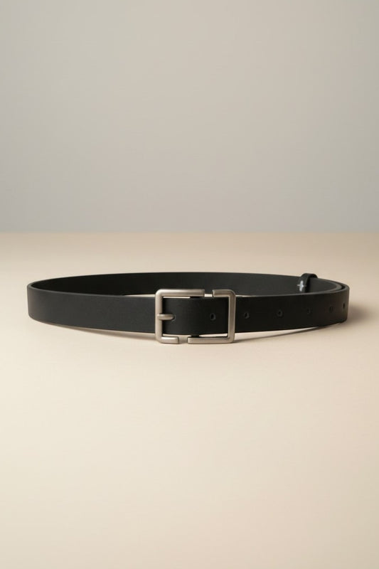 Tuck It black leather belt with a silver rectangular buckle and multiple holes for adjustable fit.