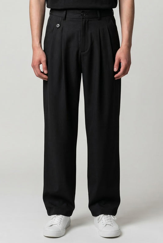 Tuck It black wide-leg pleated trousers with a button closure and side pockets.