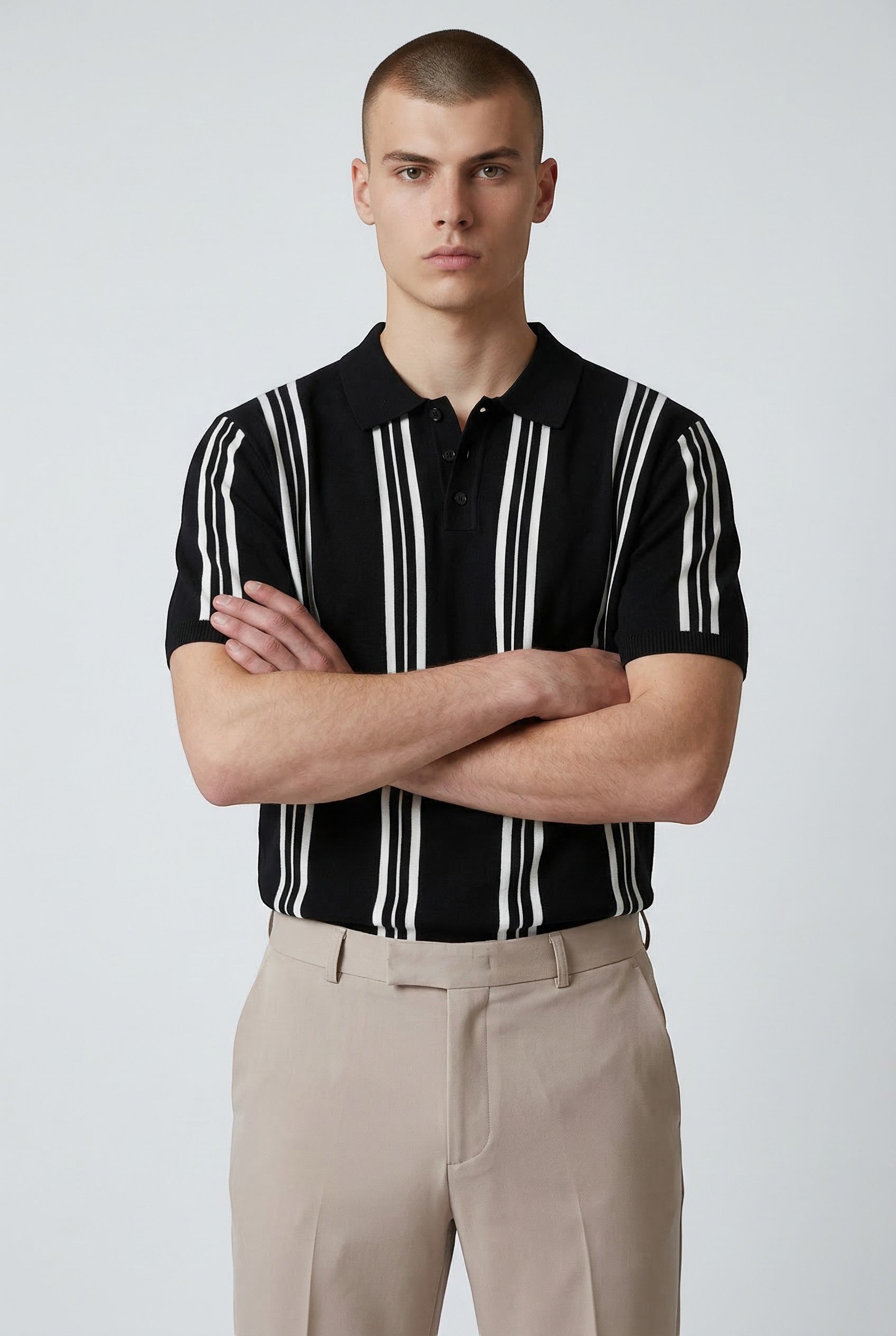 Tuck It Monaco black knit polo shirt with white vertical stripes and short sleeves.